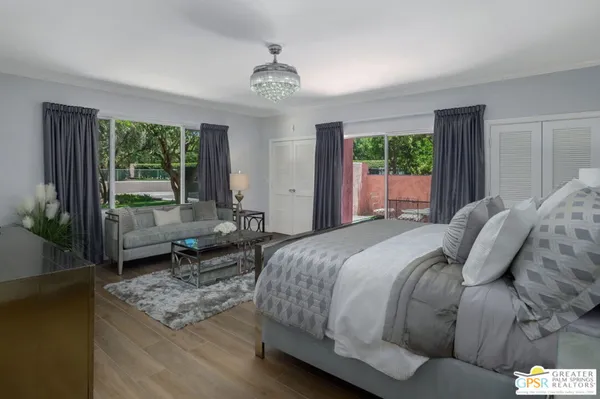 a bedroom with a bed and a potted plant