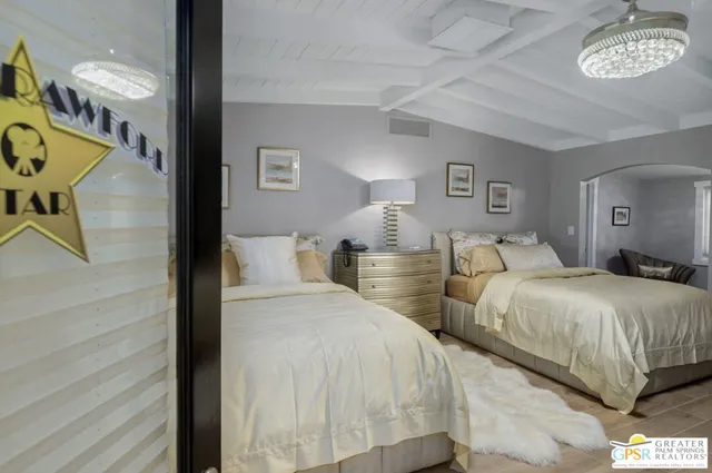 a bedroom with two beds and a window