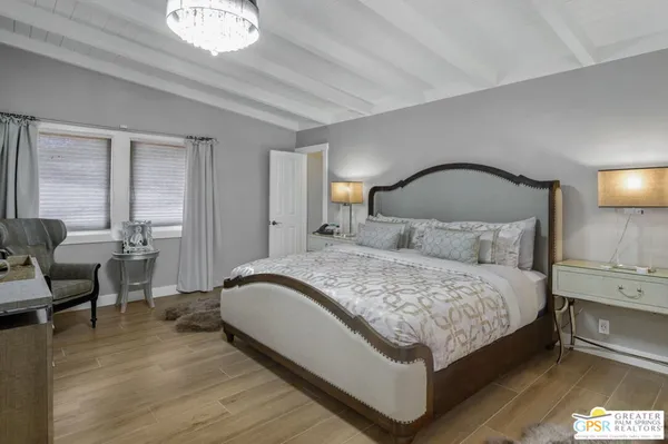 a bedroom with bed and a night stand