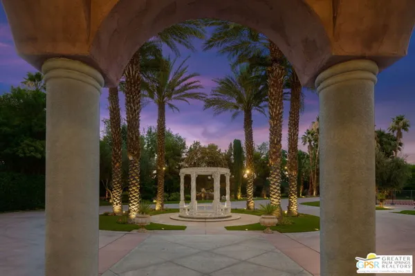 a view of lake with a palm and palm trees