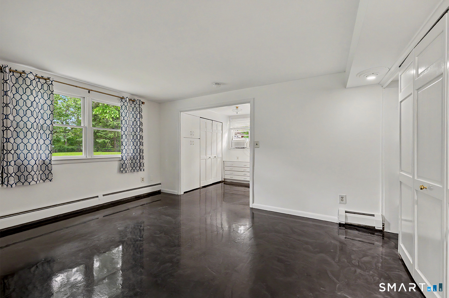 19 Geneva Road Norwalk, CT 06850 - Photo 23 of 33 an empty room with wooden floor and windows