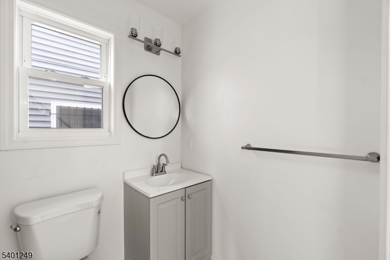 390 Clinton Place Newark, NJ 07112 - Photo 9 of 17 a bathroom with a sink and a mirror