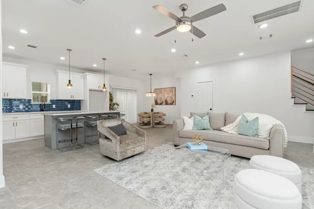 a living room with furniture and kitchen view