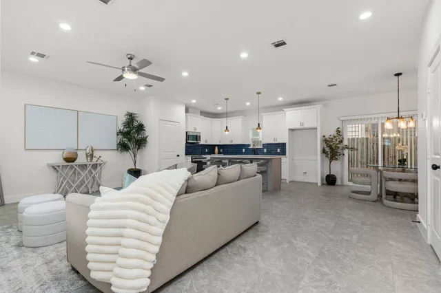 a living room with furniture and kitchen view