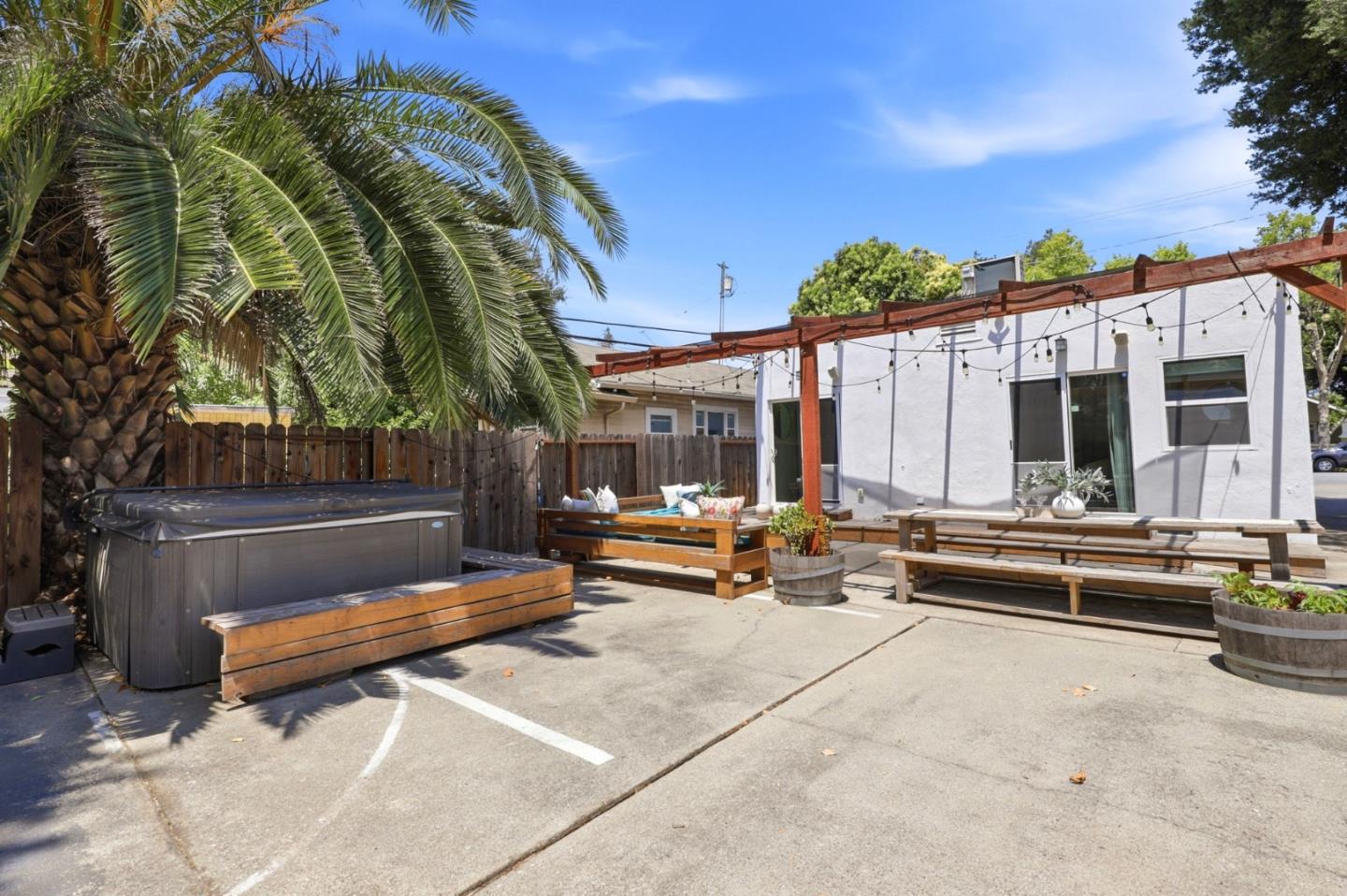 140 Second Street Gilroy, CA 95020 - Photo 31 of 33 a view of a patio with a table and chairs under an umbrella with large trees