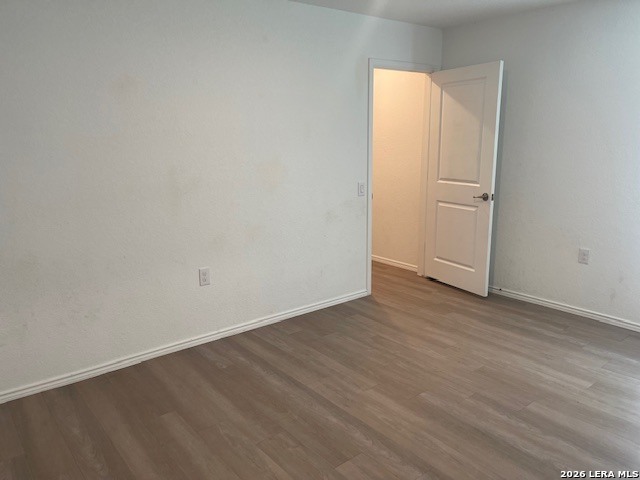 918 Cook Bend San Antonio, TX 78221 - Photo 12 of 21 an empty room with wooden floor and door