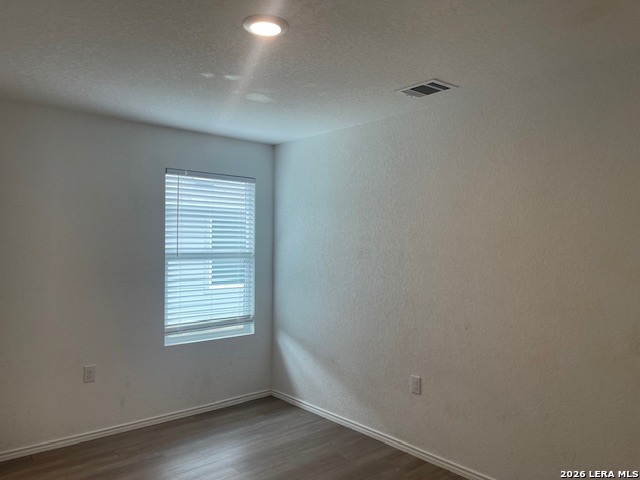 918 Cook Bend San Antonio, TX 78221 - Photo 13 of 21 an empty room with wooden floor and windows