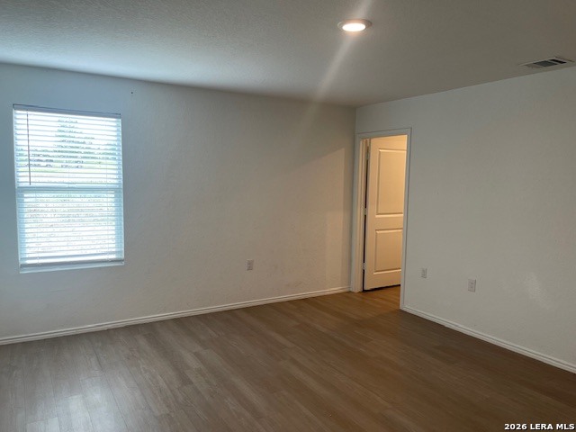 918 Cook Bend San Antonio, TX 78221 - Photo 15 of 21 an empty room with wooden floor and windows