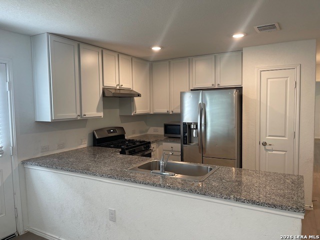 918 Cook Bend San Antonio, TX 78221 - Photo 4 of 21 a kitchen with kitchen island granite countertop cabinets a refrigerator and a sink