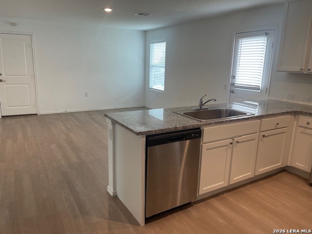 918 Cook Bend San Antonio, TX 78221 - Photo 6 of 21 a utility room with granite countertop cabinets sink and window