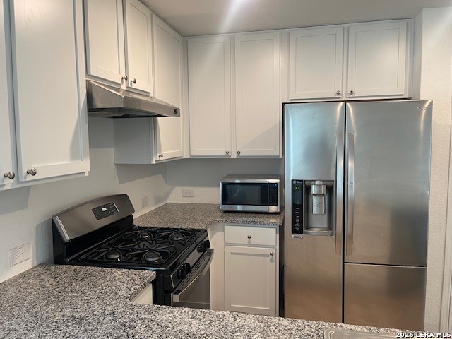918 Cook Bend San Antonio, TX 78221 - Photo 7 of 21 a kitchen with stainless steel appliances granite countertop a refrigerator stove top oven and cabinets