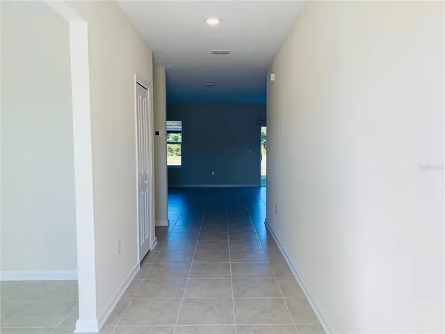 a view of kitchen with furniture and an empty refrigerator
