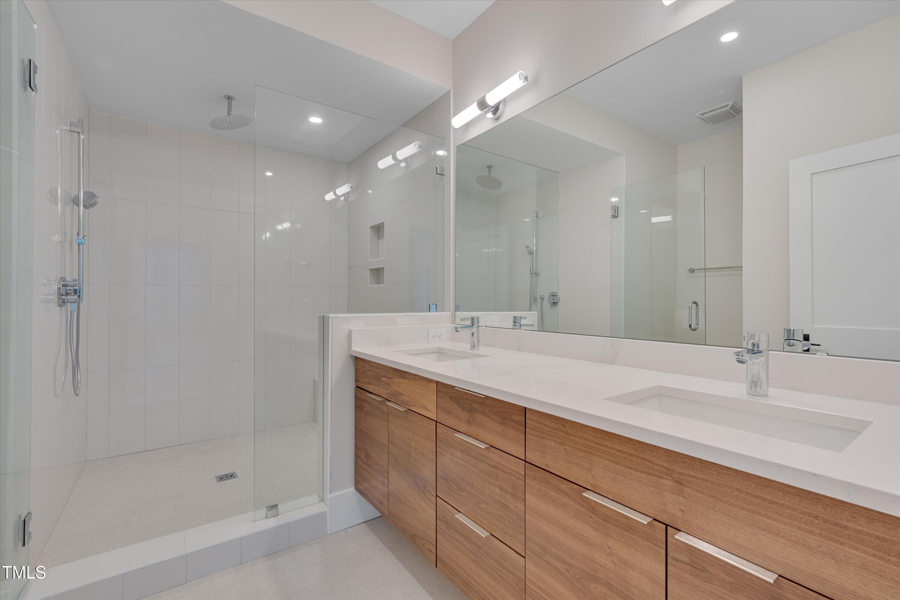 779 Willard Street Durham, NC 27701 - Photo 14 of 32 a bathroom with double sink and a mirror