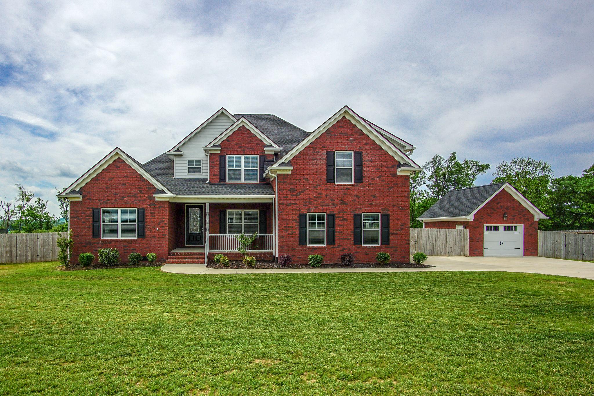 a front view of house with yard and green space
