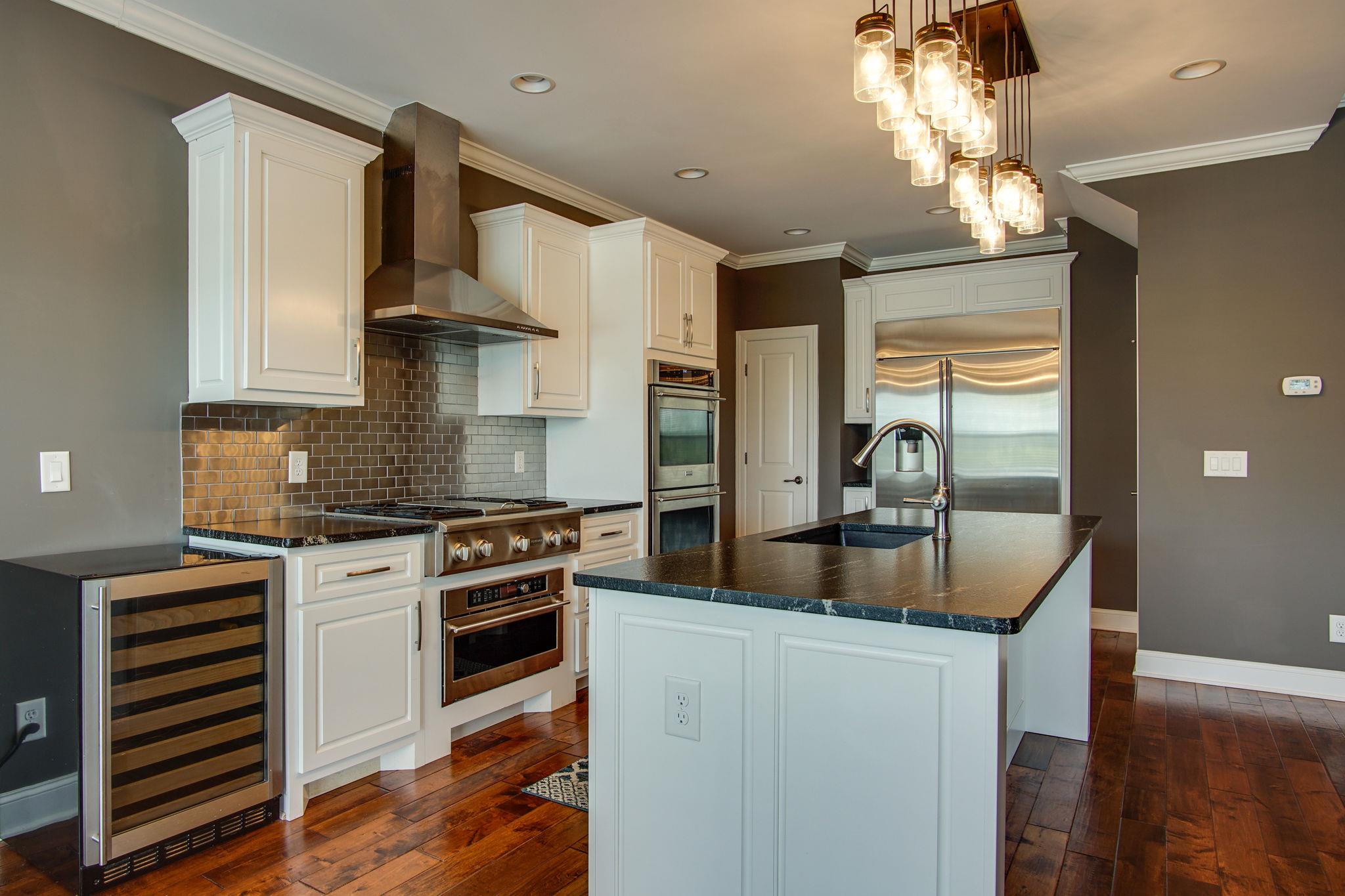 3029 Briley Path Columbia, TN 38401 - Photo 12 of 28 a kitchen with kitchen island granite countertop a sink stainless steel appliances and cabinets