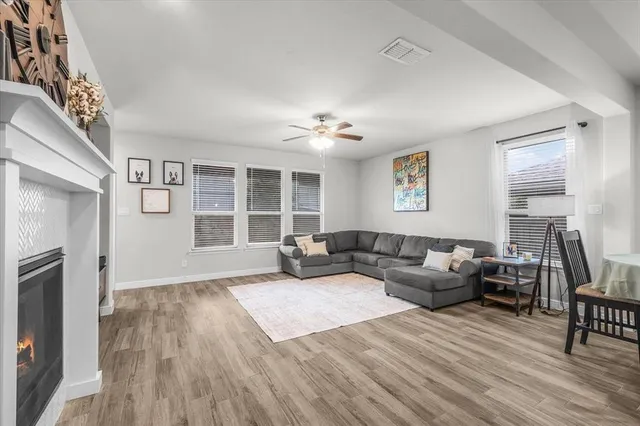a living room with furniture and a fireplace