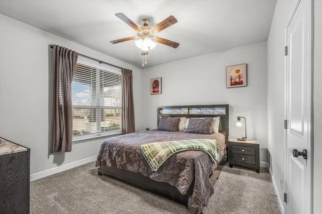 a bedroom with a bed and a large window