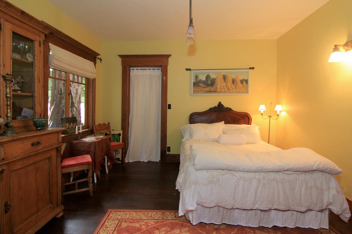 6360 Glen Haven Road Soquel, CA 95073 - Photo 23 of 50 a bedroom with a bed and wooden floor