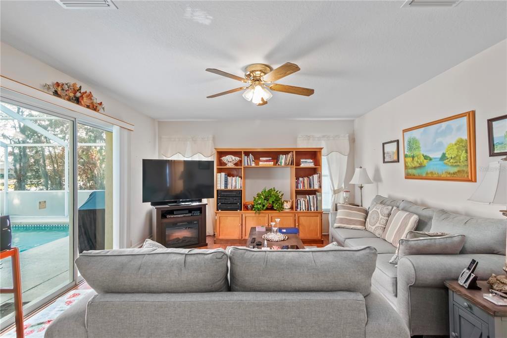 67 Lake Diamond Boulevard Ocala, FL 34472 - Photo 12 of 32 a living room with furniture and a flat screen tv