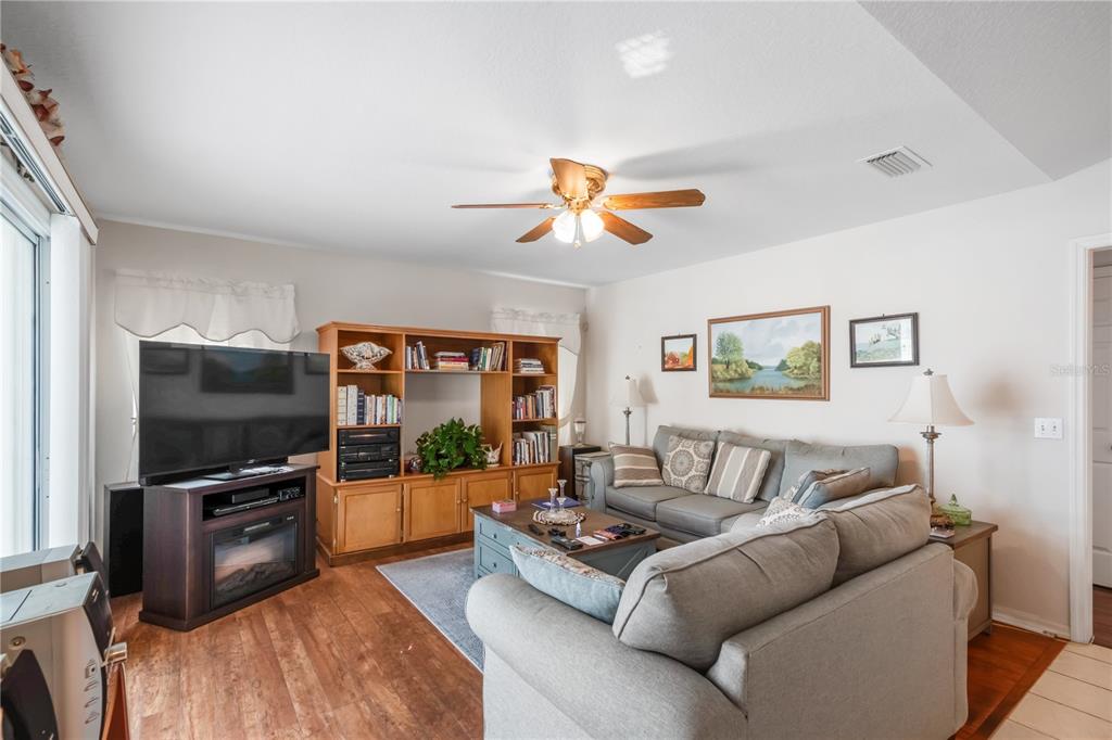 67 Lake Diamond Boulevard Ocala, FL 34472 - Photo 13 of 32 a living room with furniture and a flat screen tv