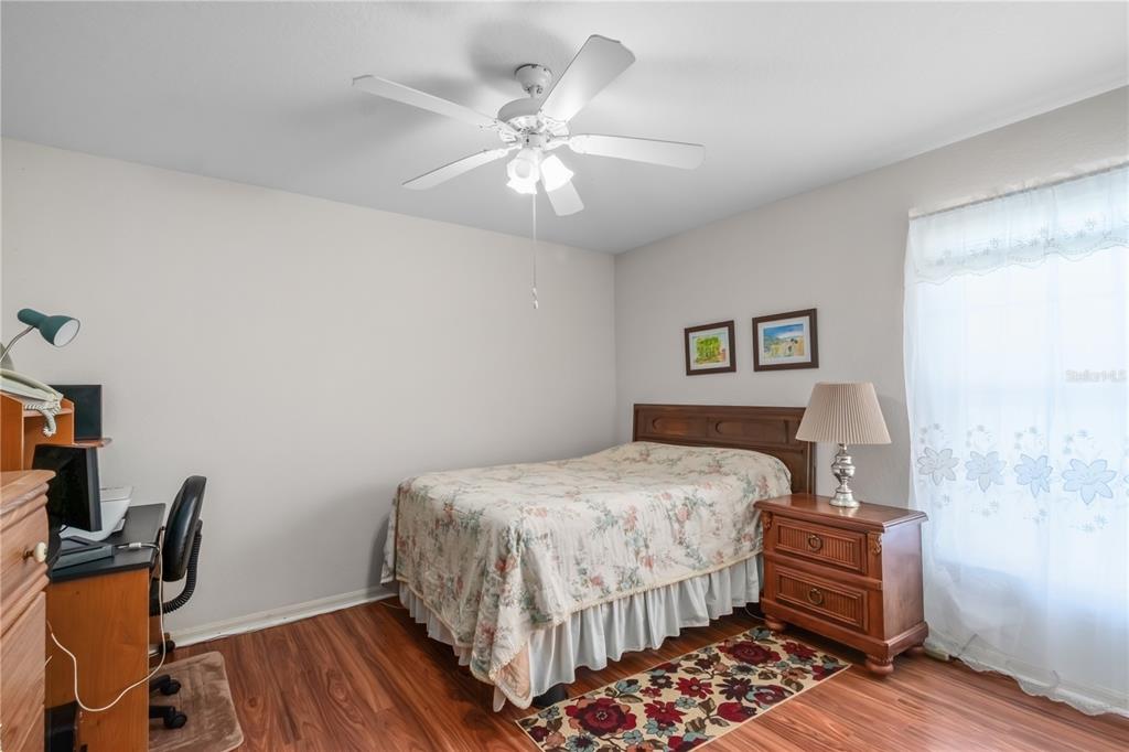 67 Lake Diamond Boulevard Ocala, FL 34472 - Photo 18 of 32 a bedroom with a bed and wooden floor