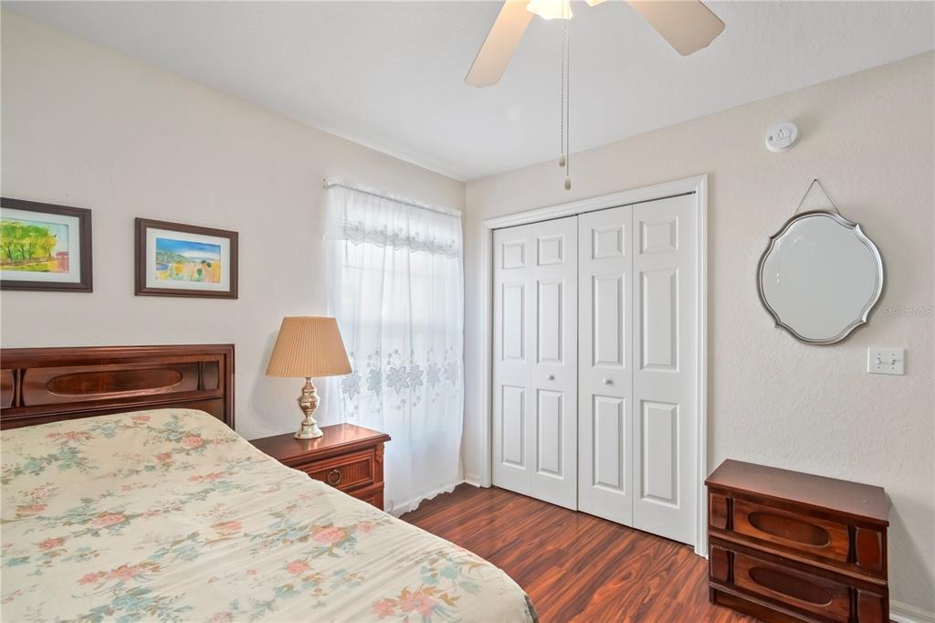 67 Lake Diamond Boulevard Ocala, FL 34472 - Photo 19 of 32 a bedroom with a bed and a chandelier