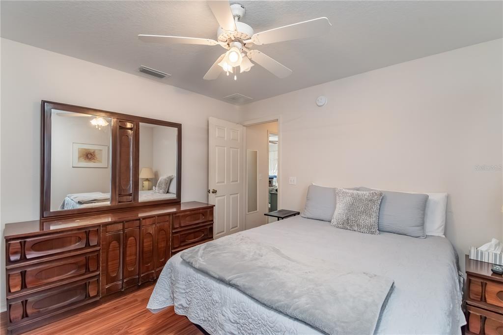 67 Lake Diamond Boulevard Ocala, FL 34472 - Photo 22 of 32 a bedroom with a bed and a large mirror on the dresser