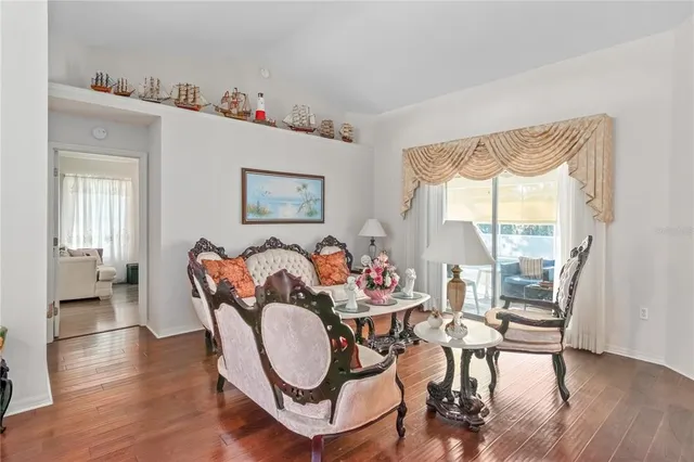a view of a dining room with furniture window and wooden floor