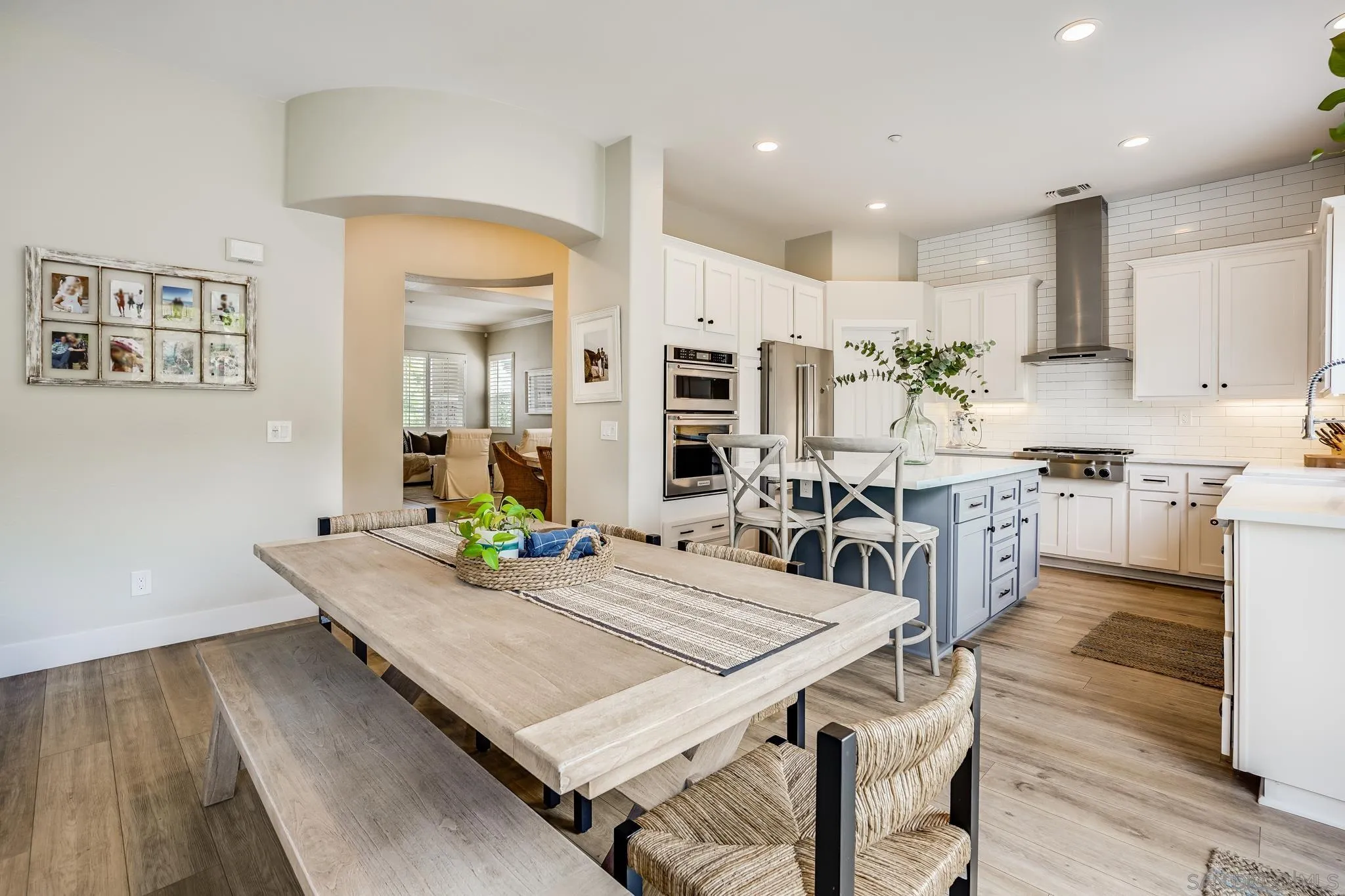 1126 Alexandra Lane Encinitas, CA 92024 - Photo 11 of 36 a kitchen with stainless steel appliances granite countertop a kitchen island a stove a table and chairs in it
