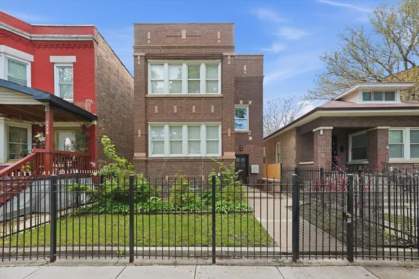 a view of a brick building next to a yard