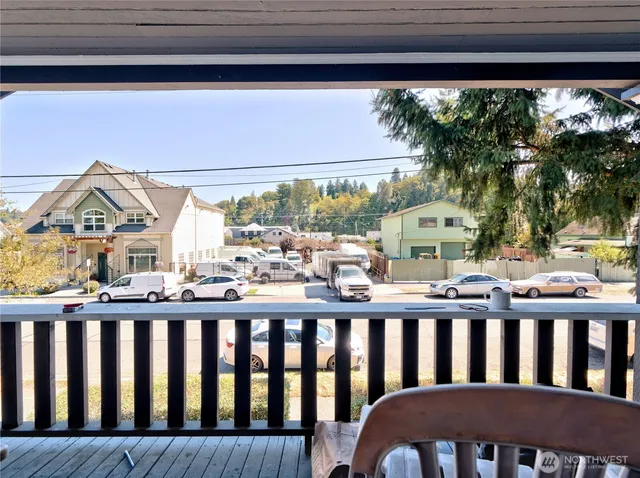 a balcony view with a couple of chairs in front of it