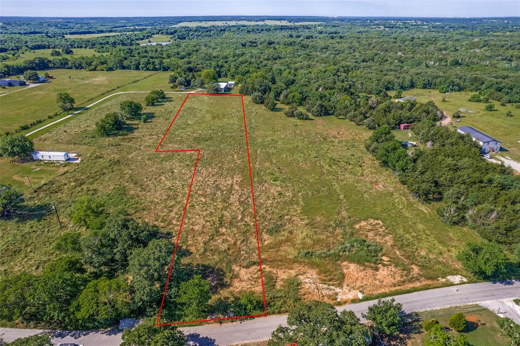 an aerial view of a houses with a yard