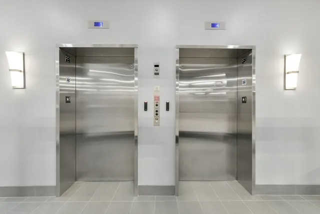a kitchen with white cabinets and refrigerator