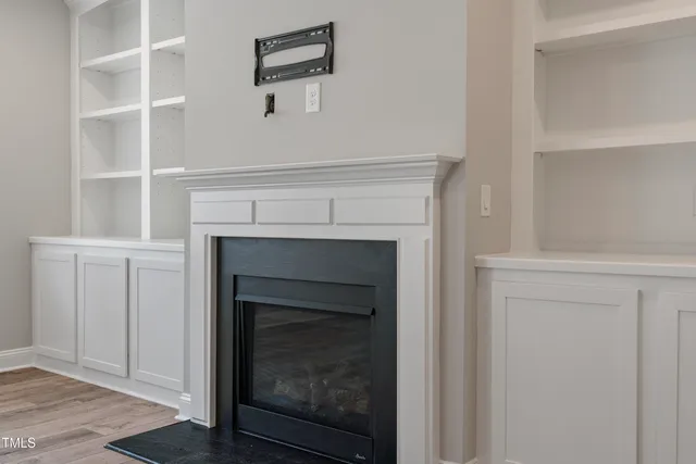 a room with a fireplace and a painting