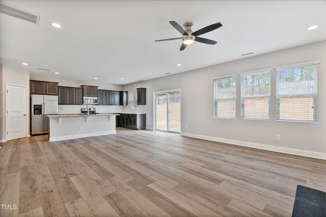 a kitchen with stainless steel appliances granite countertop a refrigerator a sink and a stove