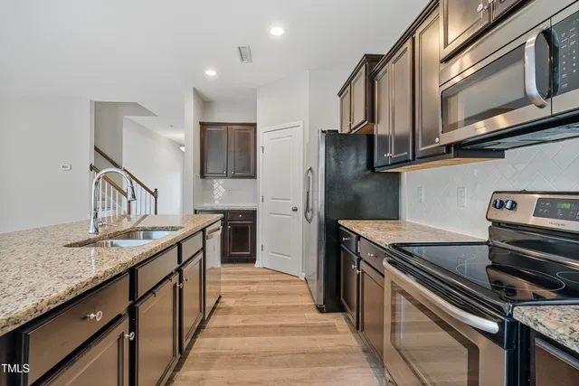 a large kitchen with stainless steel appliances