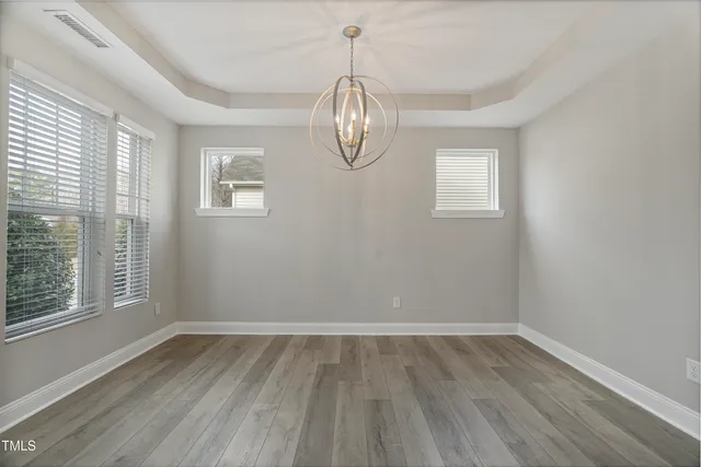 a view of room with window and wooden floor