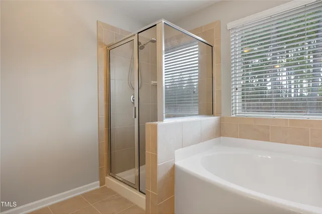 a white bath tub sitting next to a window