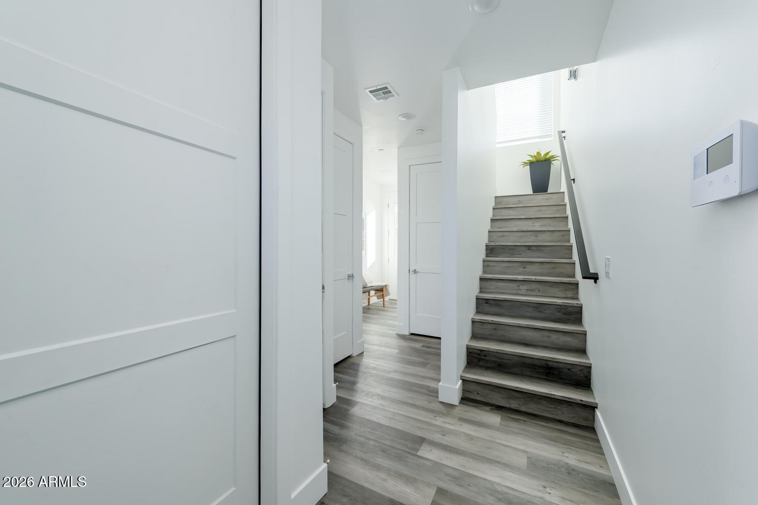 1349 West Osborn Road, Unit 6 Phoenix, AZ 85013 - Photo 11 of 37 a view of a hallway with wooden floor and stairs
