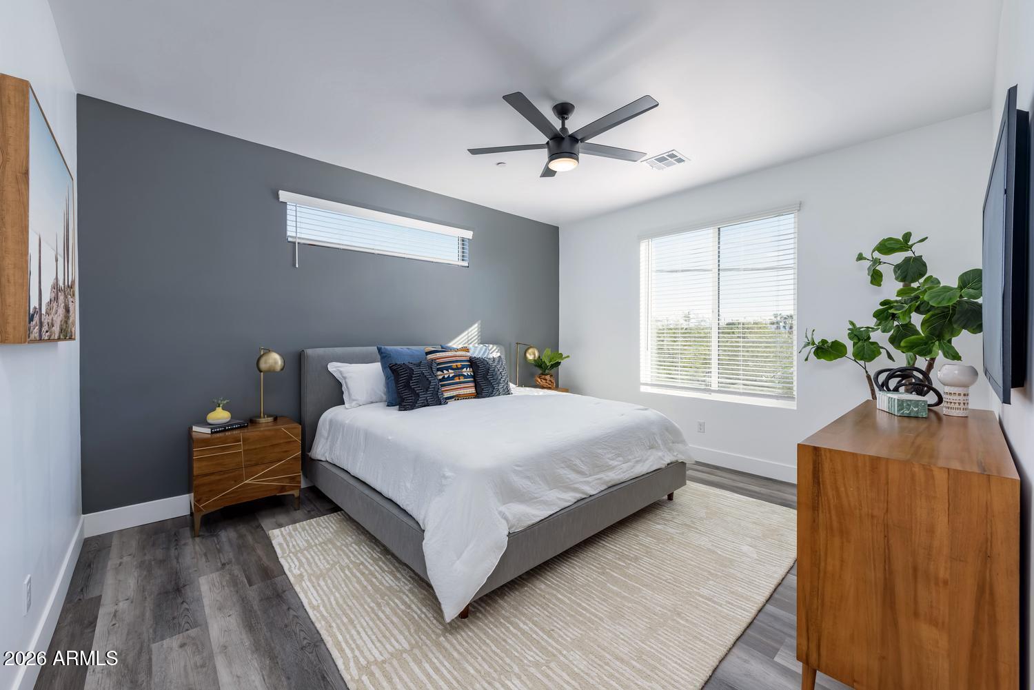 1349 West Osborn Road, Unit 6 Phoenix, AZ 85013 - Photo 17 of 37 a bedroom with a large bed and a chandelier