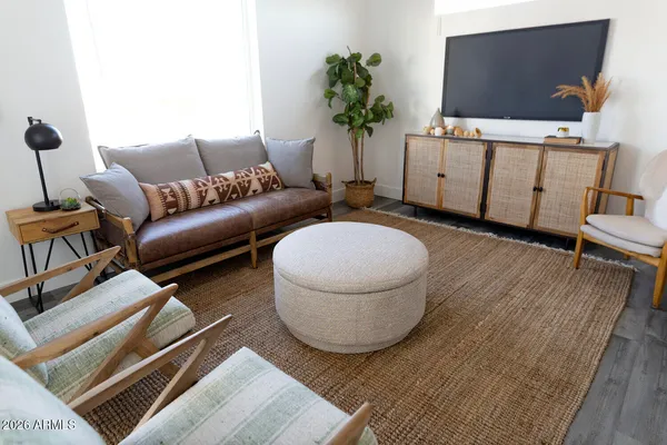 a living room with furniture and a flat screen tv