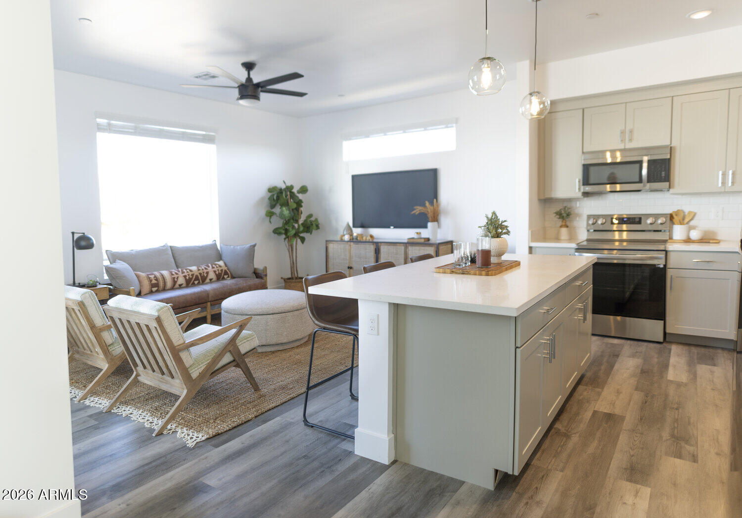 1349 West Osborn Road, Unit 6 Phoenix, AZ 85013 - Photo 19 of 37 a large white kitchen with a stove a sink dishwasher and a dining table with wooden floor
