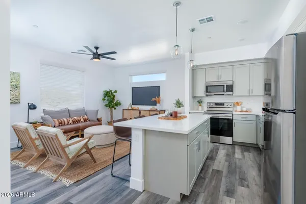 a kitchen with a sink stainless steel appliances and white cabinets