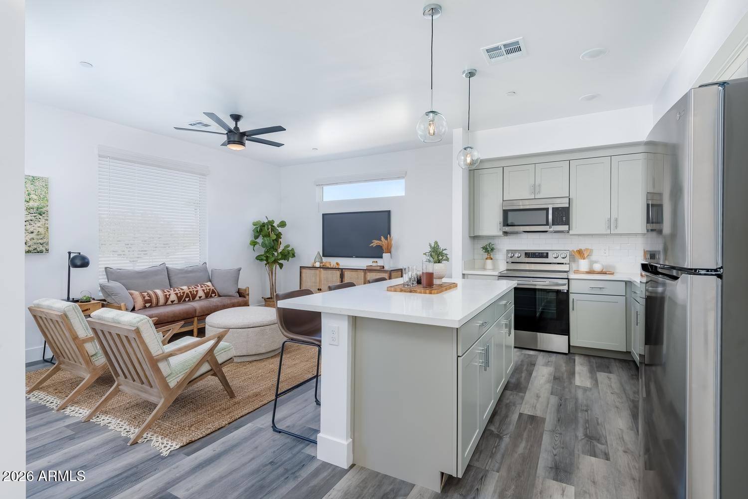 1349 West Osborn Road, Unit 6 Phoenix, AZ 85013 - Photo 3 of 37 a kitchen with a sink stainless steel appliances and white cabinets