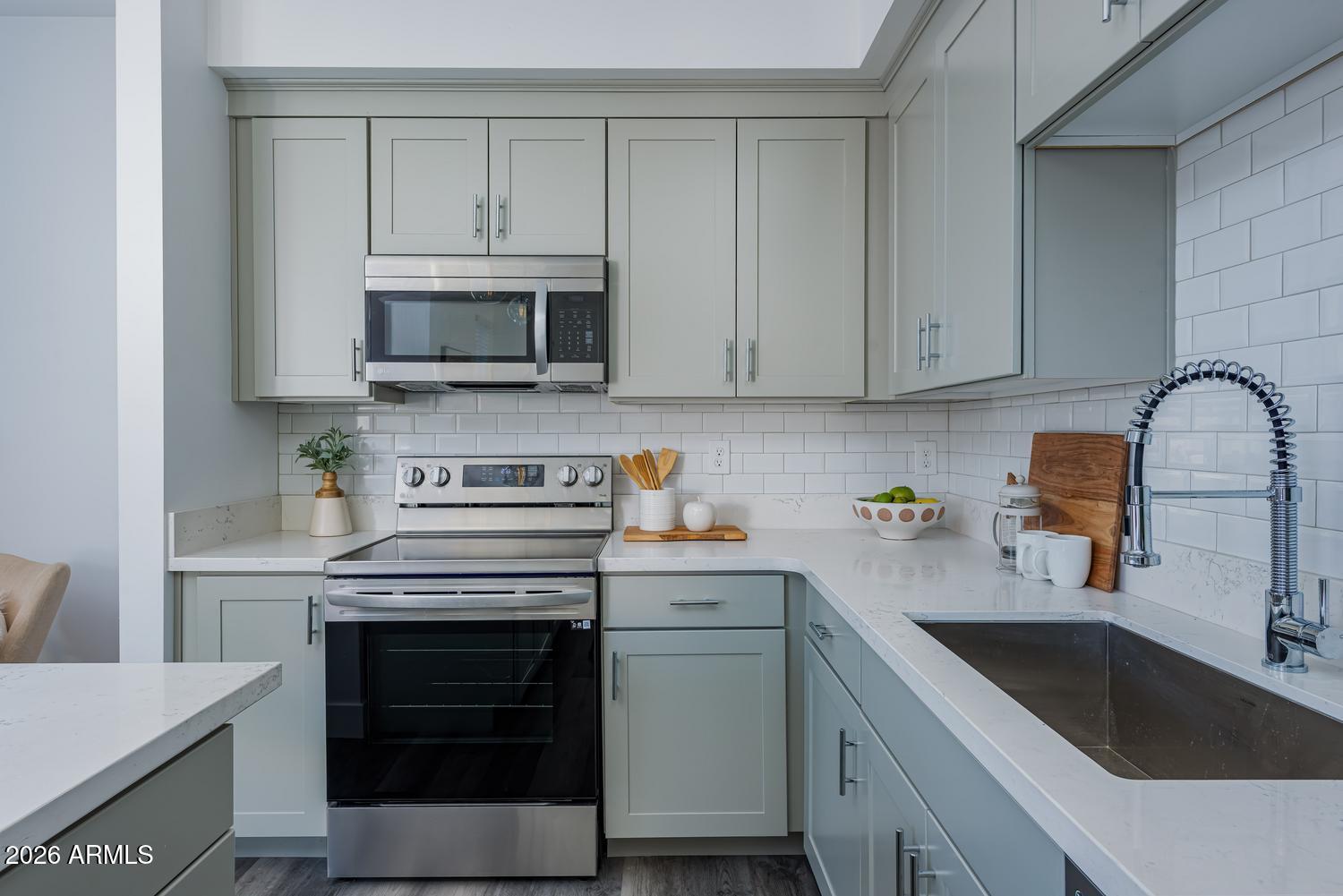 1349 West Osborn Road, Unit 6 Phoenix, AZ 85013 - Photo 7 of 37 a kitchen with cabinets stainless steel appliances and a sink