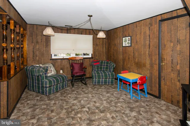 a living room with furniture a rug and a window