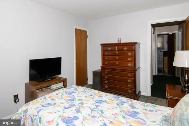 a bedroom with a bed and a television