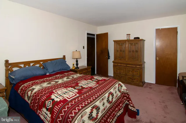 a bedroom with furniture and a dresser