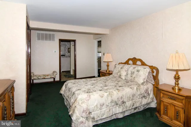 a bed room with a bed and a television