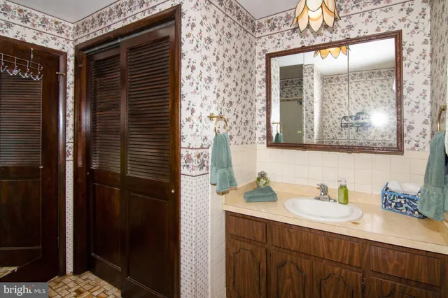 a bathroom with a granite countertop shower and a sink